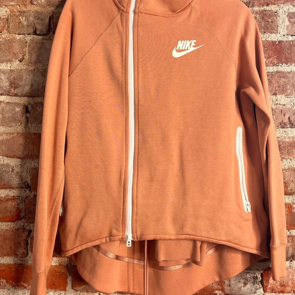 Peach Nike hoodie.